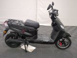 a scooter that is parked on a checkered floor