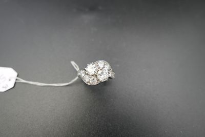a close up of a diamond ring on a black surface