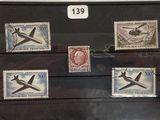 four stamps on a display case with a picture of a plane
