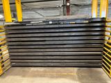 a large stack of steel plates stacked on top of each other in a warehouse