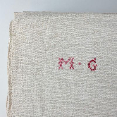an image of a close up of a piece of cloth with a red cross stitching on it