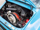 a blue car with a engine in the trunk of it