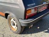 a car that is parked on the gravel road