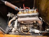 a close up of an old car engine on a wooden table