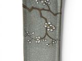 a small rectangular plate with a design of flowers on it