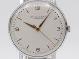 a close up of a wrist watch with a white dial and brown leather strap