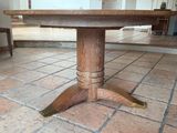 a wooden table that is sitting on a tile floor