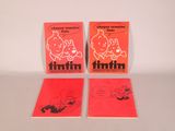 three red books sitting on top of a table next to each other