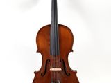 an old violin sitting on top of a white surface