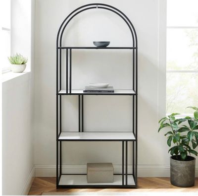 an image of a black and white shelf in a room with a potted plant