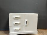 an image of a white dresser with three drawers on top of it