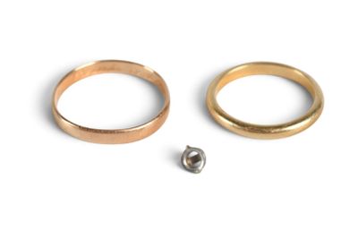two rings and a screw on a white surface