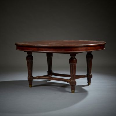 an oval mahogany table with turned legs and a wooden top