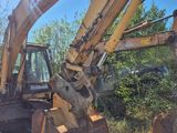 a bulldozer that is sitting in the grass