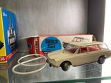 a toy car that is sitting on a shelf next to a box