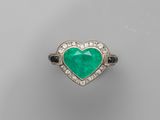 an emerald and diamond heart ring