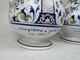 two vases that have been decorated with blue and white designs