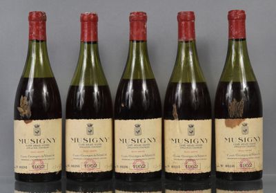 six bottles of wine are lined up in a row on a table