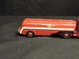 a red toy truck with a white stripe on the side