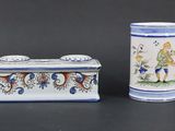 pair of blue and white vases with designs on them on a black surface