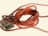 a red cord that is connected to an electrical outlet