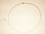 a drawing of a necklace on a table with a pen