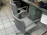 a photo of a hair salon with chairs and a counter