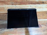 a black tablet computer sitting on a wooden table