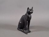 a statue of a cat that is sitting on a table