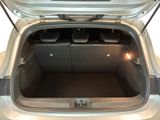 a trunk of a silver car with its doors open