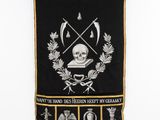 black and gold banner with a skull and other symbols on it