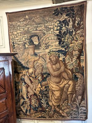 a tapestry hanging on the wall next to a dresser