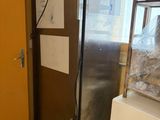 an image of a refrigerator in a kitchen with a lot of stuff on it