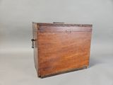 an old wooden box sitting on top of a white surface