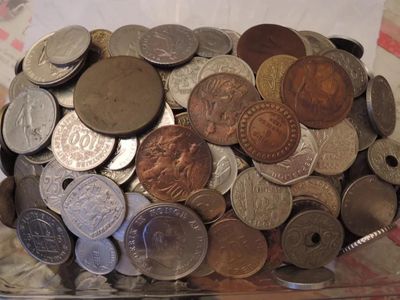 a glass container filled with coins on a table
