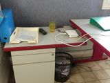 a desk with a computer and a printer on it in a room