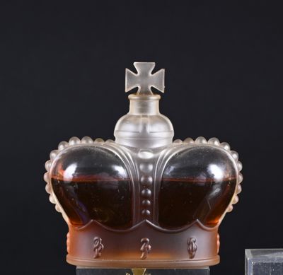 a glass bottle with a crown on top of it