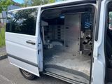 a white van with its door open in a parking lot