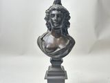 a bronze bust of a woman on a pedestal
