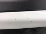 a close up of a white car with a black seat cushion