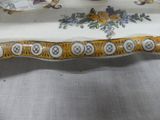 a white plate with a yellow and blue design on it