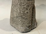 a small statue of a person sitting on a rock