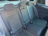 the back seats of a car with a dog sitting in the passenger seat