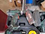 two power tools sitting in a case on the floor