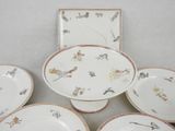 several plates and bowls sitting on a table with a white background