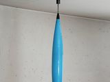 a blue light hanging from the ceiling in a room