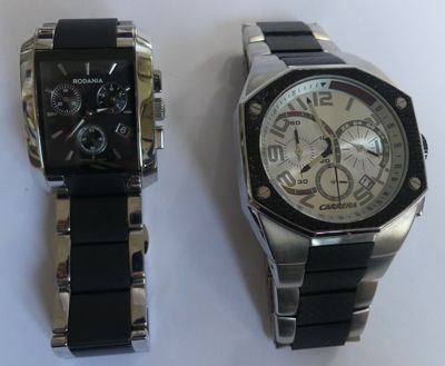 two watches sitting next to each other on a table