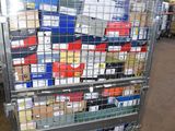 a metal cart with many boxes on it in a warehouse