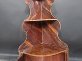 a wooden shelf that has a clock on top of it