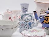 many different types of teapots and bowls on the table